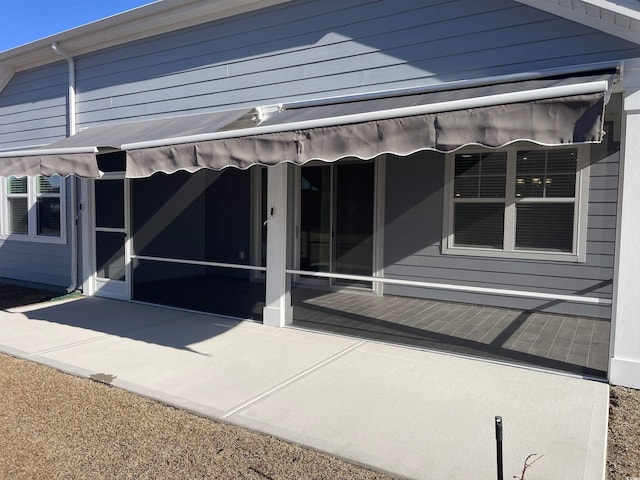 view of side of home with a patio area