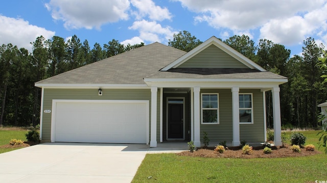 view of front of home with a garage and a front lawn