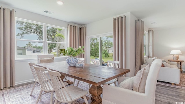 dining space with hardwood / wood-style floors