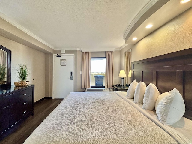 bedroom featuring a textured ceiling, baseboards, dark wood-type flooring, and crown molding