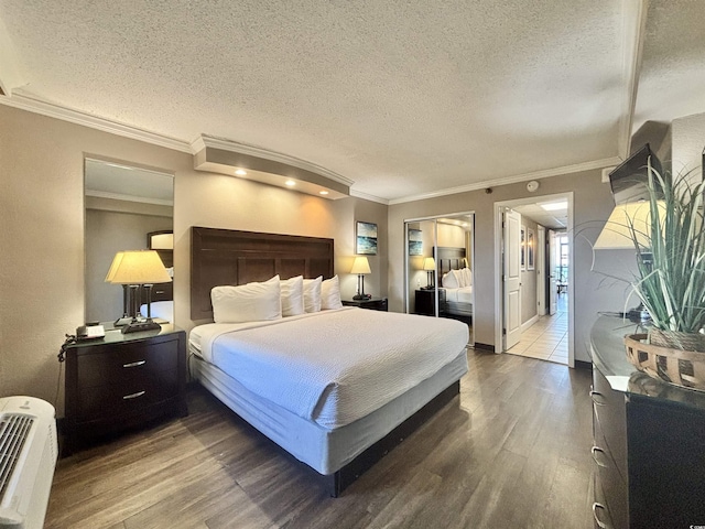 bedroom with a textured ceiling, wood finished floors, and crown molding