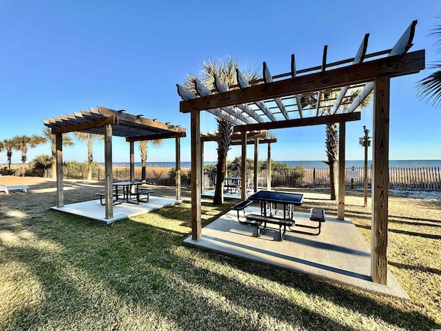 surrounding community with a yard, a patio area, a water view, and a pergola