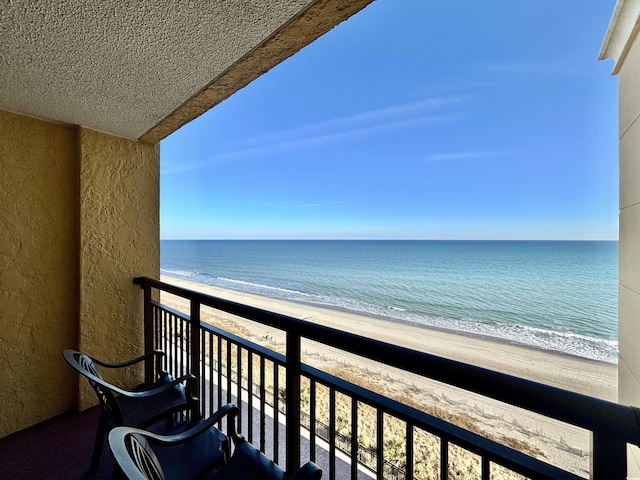 balcony with a beach view and a water view