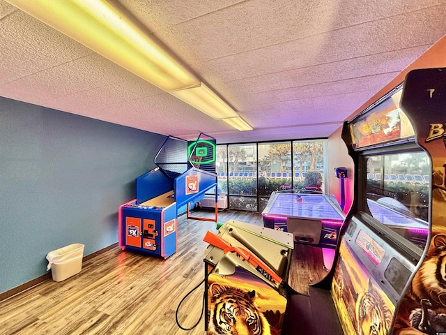 playroom with baseboards and light wood-style floors