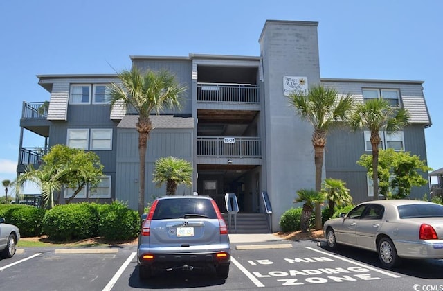 view of building exterior with uncovered parking