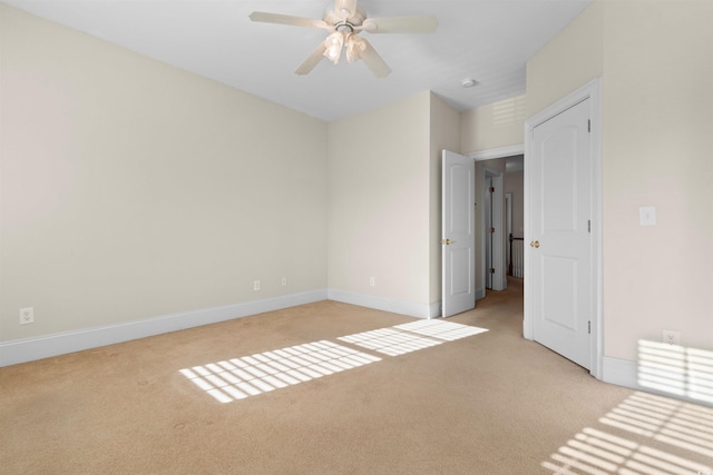 unfurnished bedroom with ceiling fan and light colored carpet