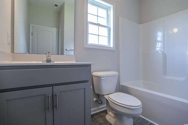 bathroom with visible vents, baseboards, toilet, wood finished floors, and vanity