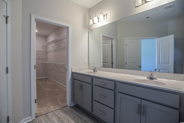 full bath featuring a sink, visible vents, and double vanity