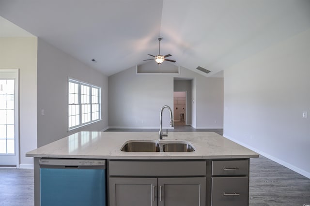 kitchen featuring dishwashing machine, gray cabinetry, open floor plan, and a sink