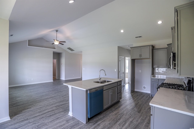 kitchen featuring stainless steel microwave, gray cabinetry, gas range, dishwasher, and a sink