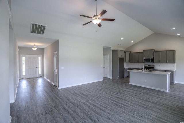 kitchen featuring open floor plan, stainless steel microwave, visible vents, and gas range oven