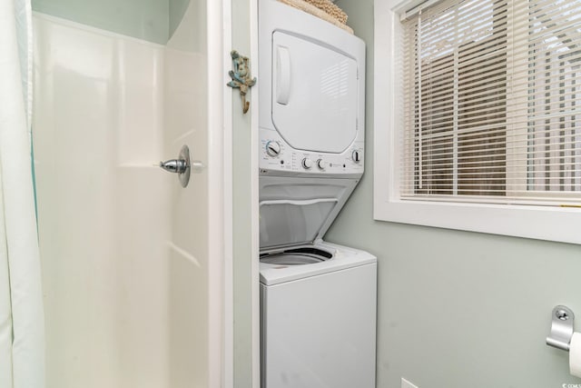 laundry room featuring stacked washer / dryer