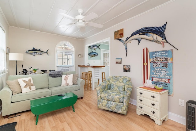 living room with hardwood / wood-style flooring, ornamental molding, and heating unit