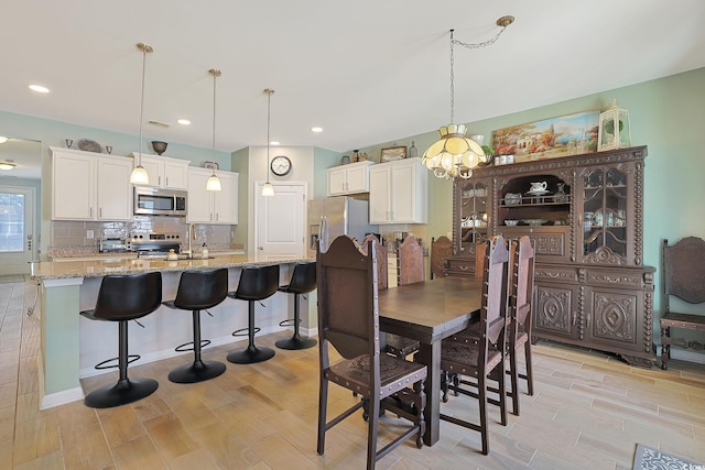 dining space with light wood-type flooring