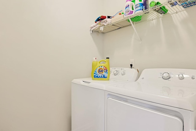 clothes washing area featuring independent washer and dryer