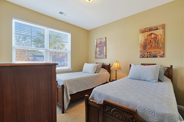 bedroom featuring light colored carpet