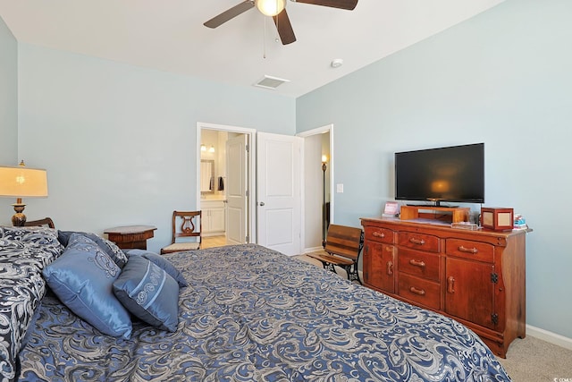 carpeted bedroom featuring ceiling fan and ensuite bath