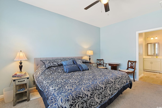 bedroom featuring ceiling fan, connected bathroom, and light carpet