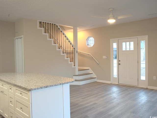 entryway with ceiling fan and light hardwood / wood-style floors