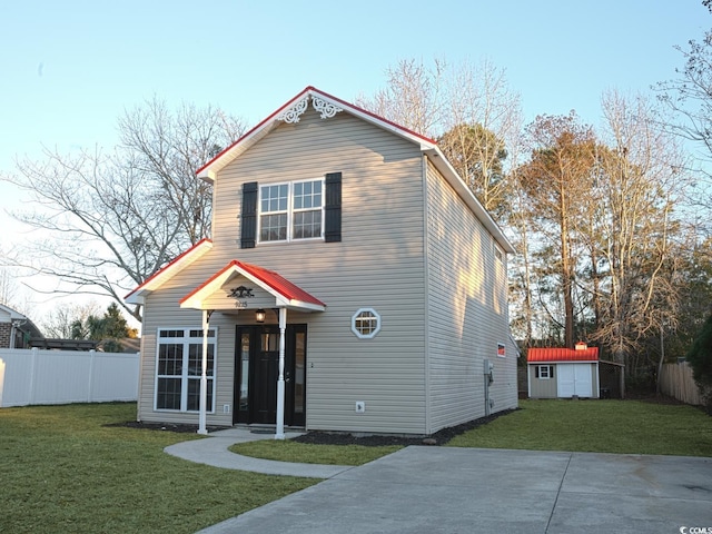 view of front property featuring a front yard and a storage unit