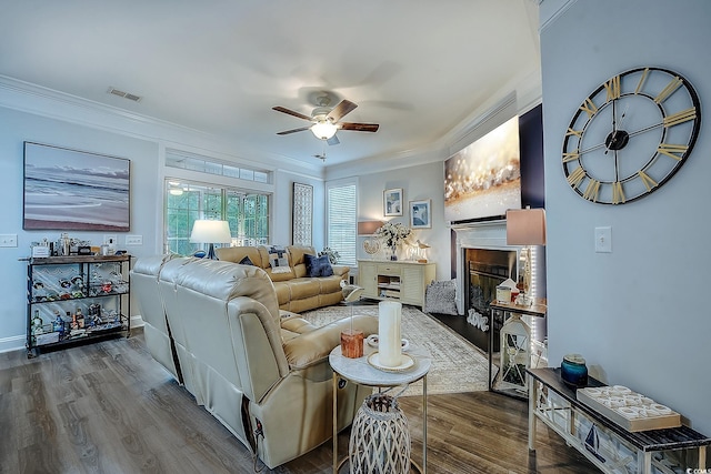 living room with crown molding, ceiling fan, and hardwood / wood-style floors