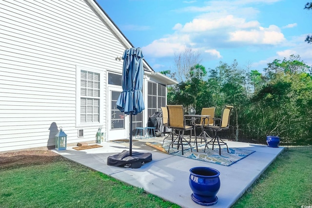 view of patio with a sunroom