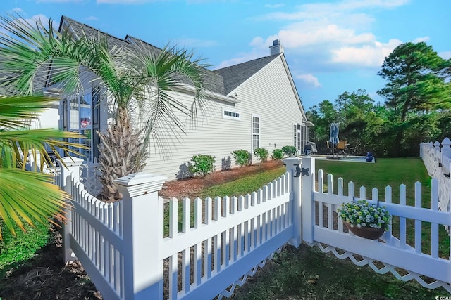 view of side of home with a lawn