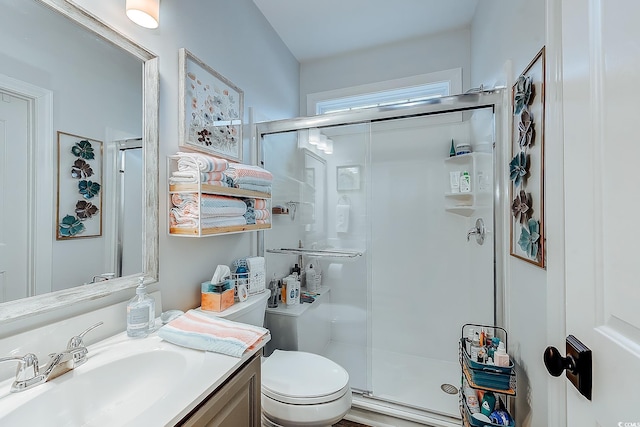 bathroom featuring vanity, toilet, and an enclosed shower