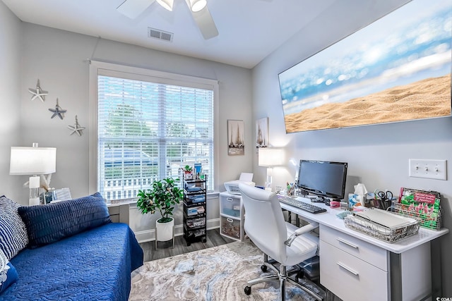 office space featuring ceiling fan, plenty of natural light, and dark hardwood / wood-style flooring