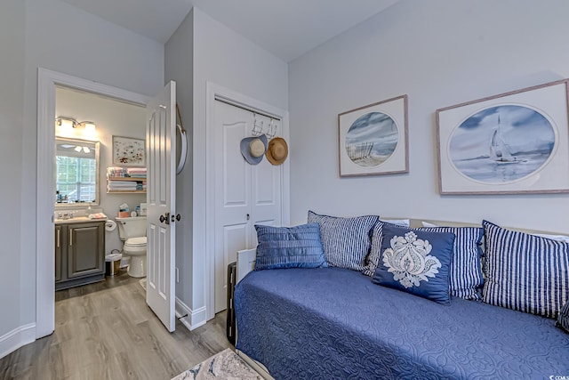 bedroom with hardwood / wood-style floors and a closet