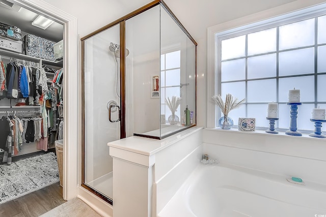 bathroom featuring hardwood / wood-style flooring and separate shower and tub