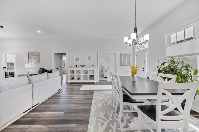 dining area featuring dark hardwood / wood-style floors and a chandelier