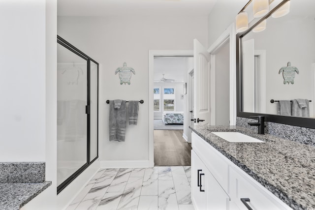 bathroom featuring vanity and a shower with door