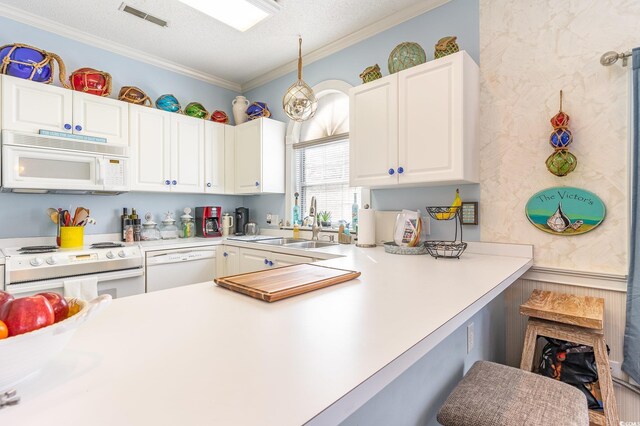kitchen featuring visible vents, white appliances, white cabinetry, a textured ceiling, and a sink