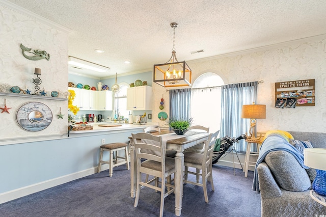 dining room with crown molding, a textured ceiling, a notable chandelier, and dark colored carpet