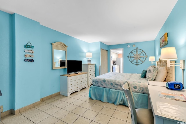 bedroom featuring light tile patterned floors and baseboards