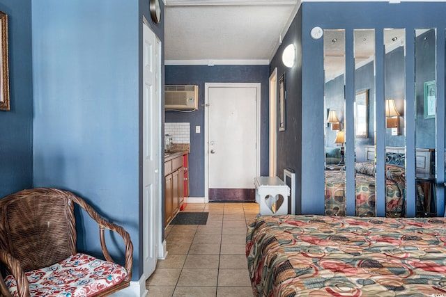 bedroom featuring light tile patterned flooring, ornamental molding, and a wall unit AC