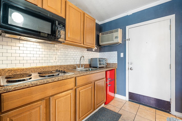 kitchen featuring stovetop, crown molding, tasteful backsplash, a wall mounted air conditioner, and light tile patterned floors