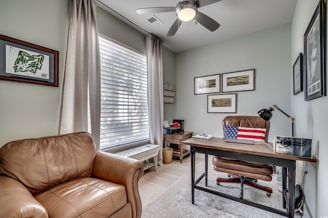 home office with ceiling fan and light wood-type flooring