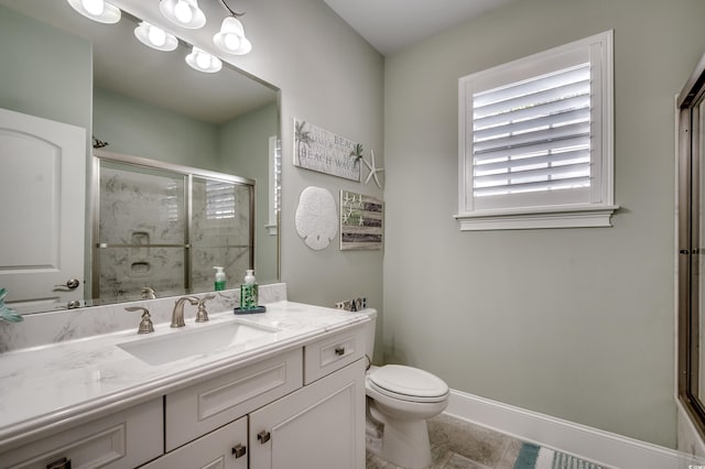 bathroom with an enclosed shower, vanity, and toilet