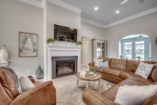 living room with crown molding and ceiling fan