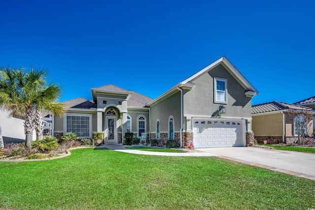 view of front of house featuring a garage and a front lawn