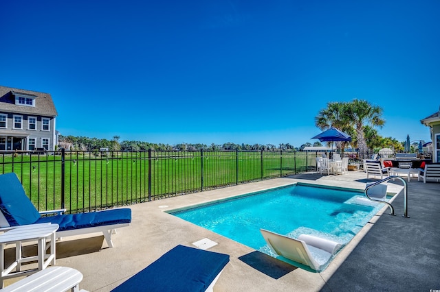 view of swimming pool featuring a yard and a patio