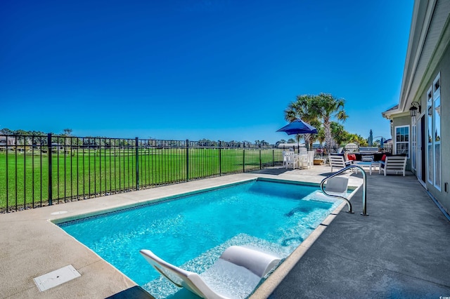 view of pool featuring a patio and a lawn