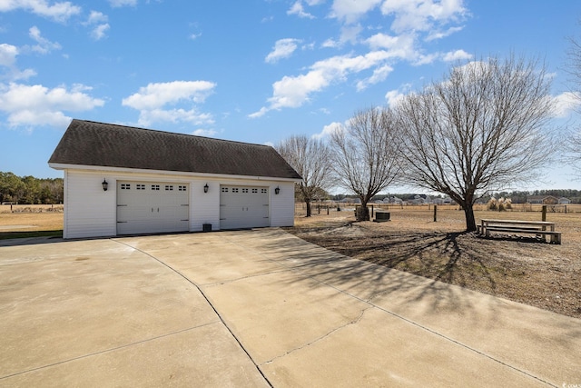 garage featuring a rural view