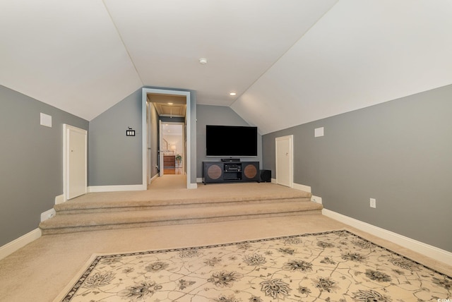 unfurnished living room with lofted ceiling and carpet