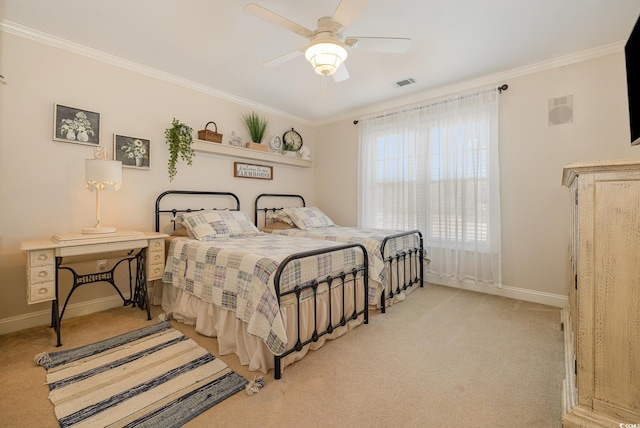 carpeted bedroom featuring ceiling fan and ornamental molding