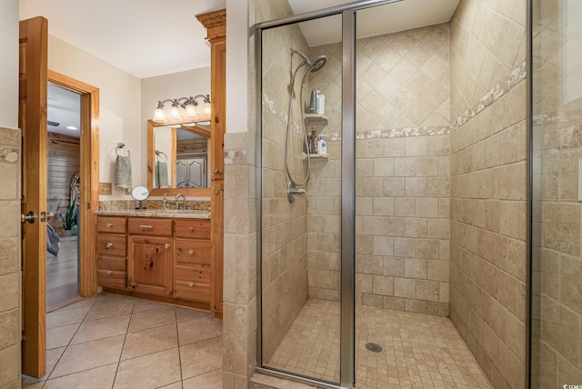 bathroom featuring tile patterned floors, vanity, and a shower with door