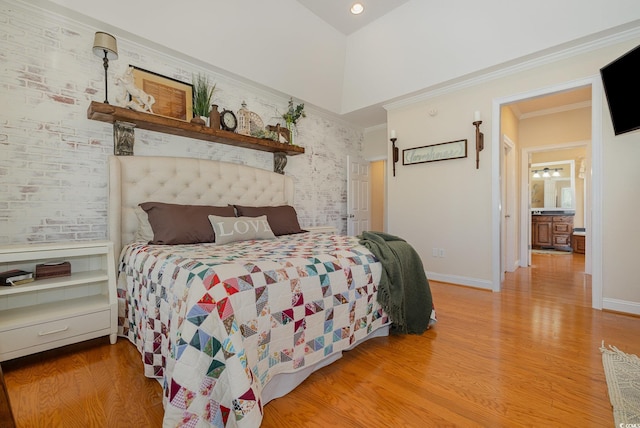 bedroom featuring crown molding, light hardwood / wood-style floors, and a towering ceiling