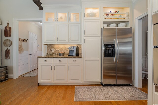 kitchen with stone countertops, light hardwood / wood-style floors, white cabinets, and stainless steel refrigerator with ice dispenser